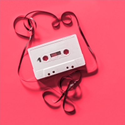 Unraveled cassette tape on red background